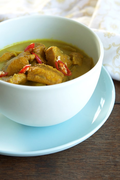 keralan fish curry in blue bowl with teatowel