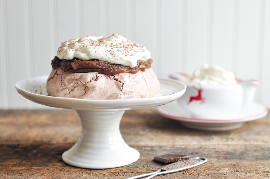 chocolate pavlova with chestnut purée on cake stand with jug of cream