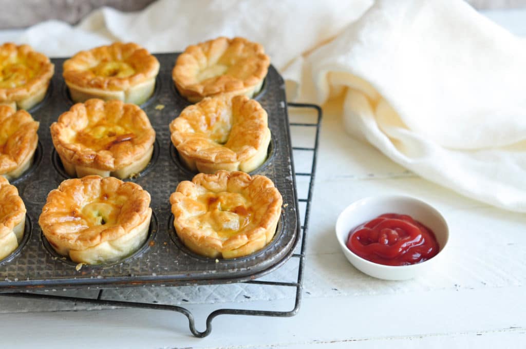 aussie meat pies in muffin tin with ketchup