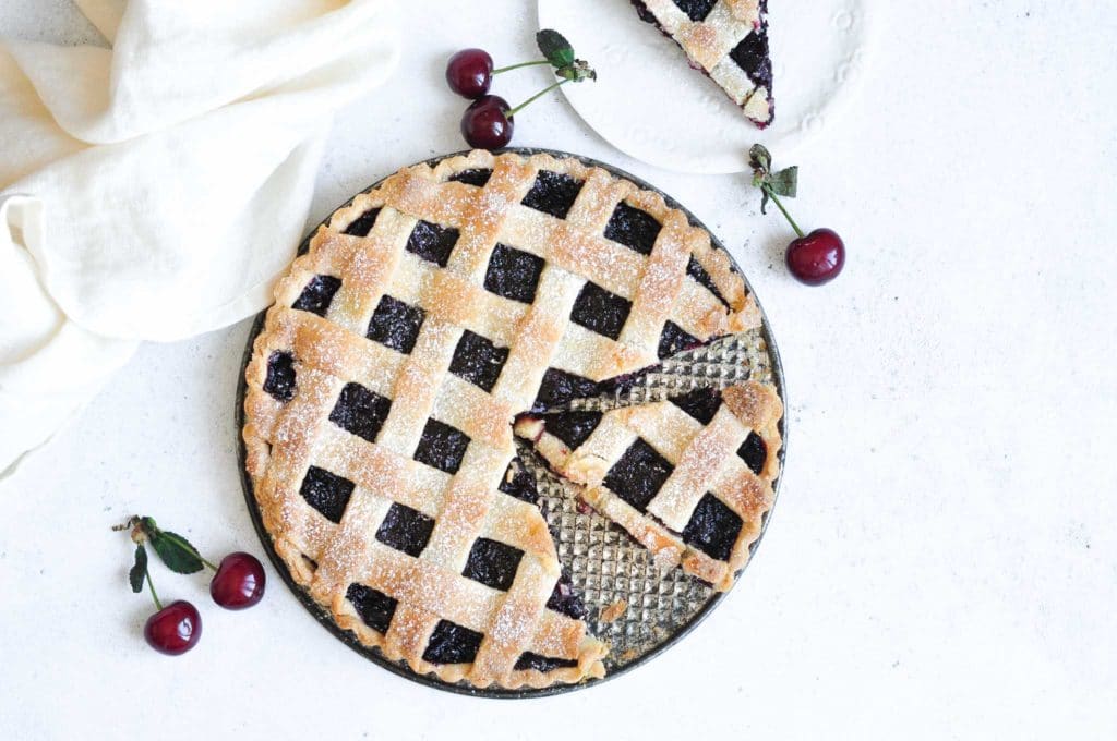 cherry pie with lattice pie crust on metal tray