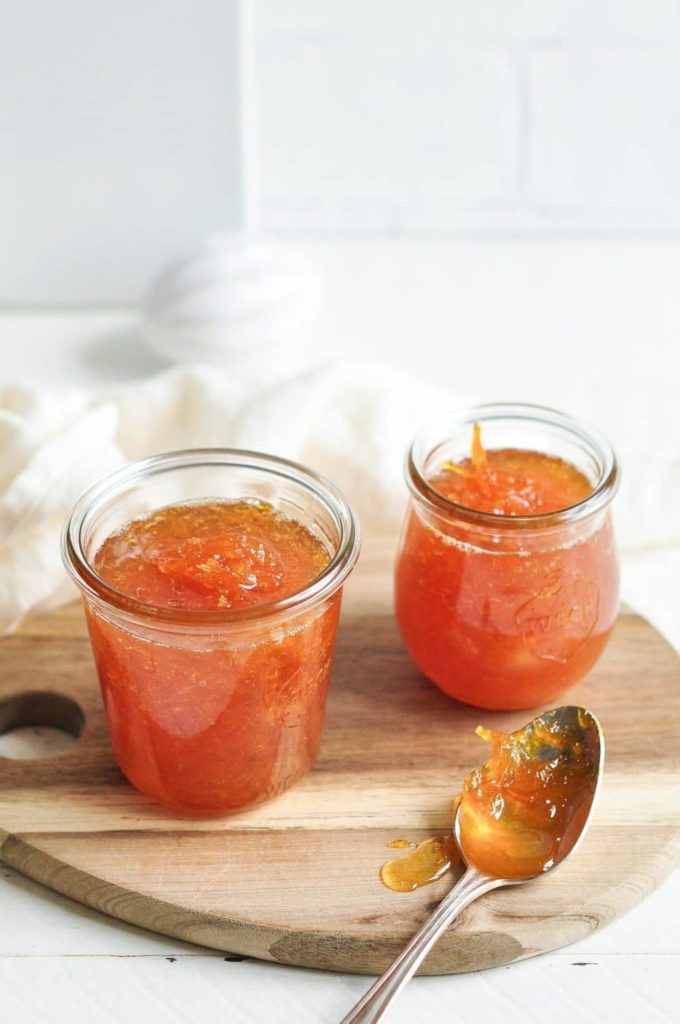 two jars filled with orange marmalade