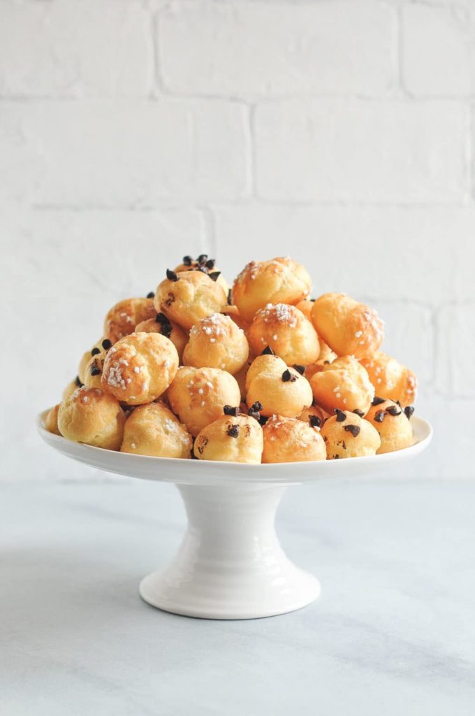 chouquettes (french cream puffs) on white cake stand