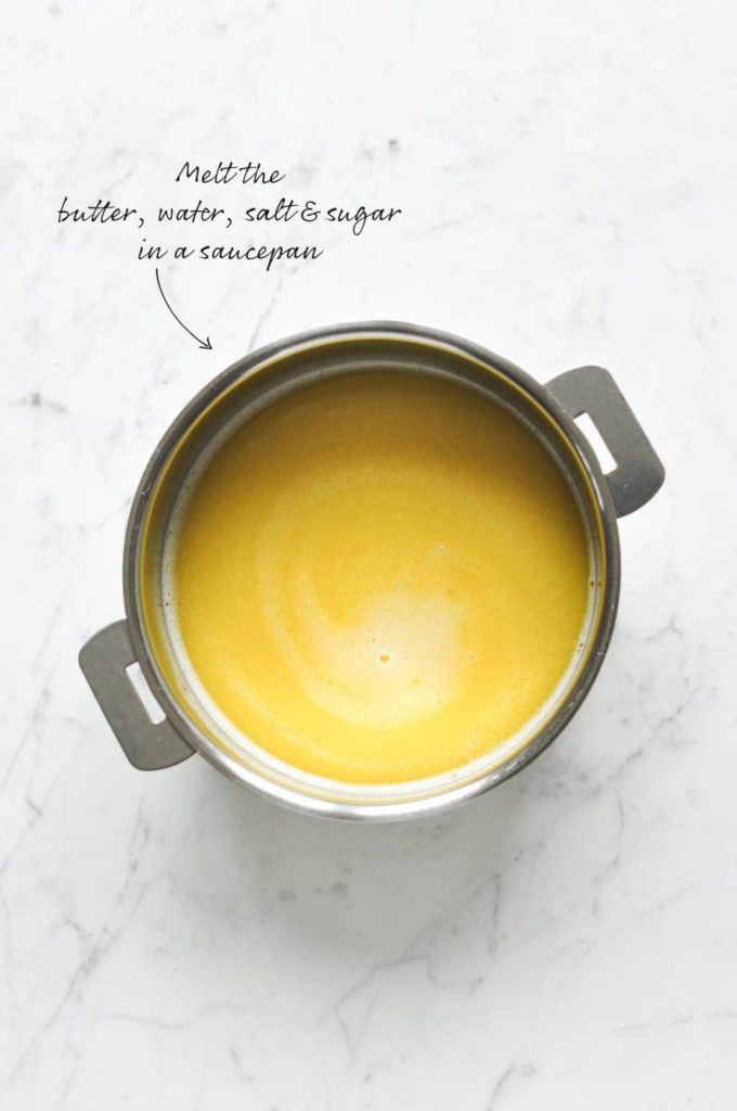 How to make choux pastry. Melt the butter, water, salt and sugar in a saucepan.