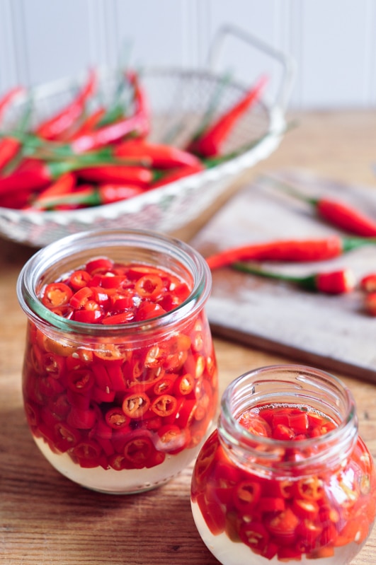 sliced pickled chillies in glass jars