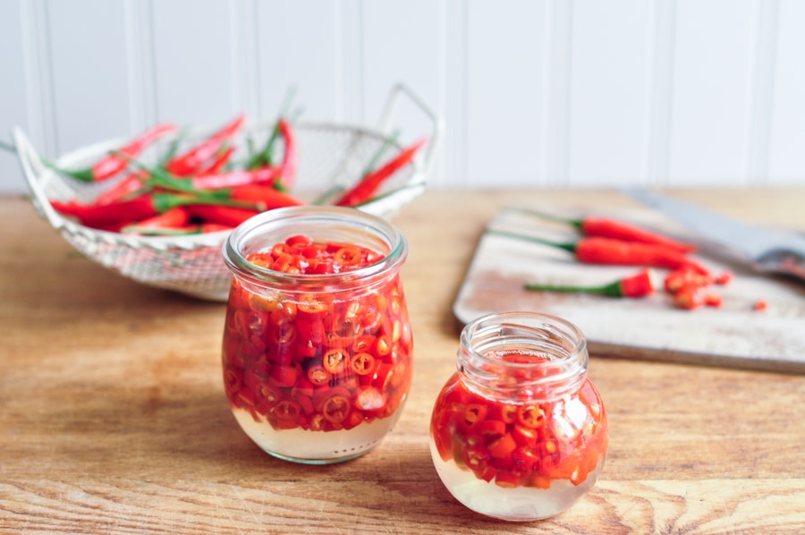 pickled chillies in glass jars