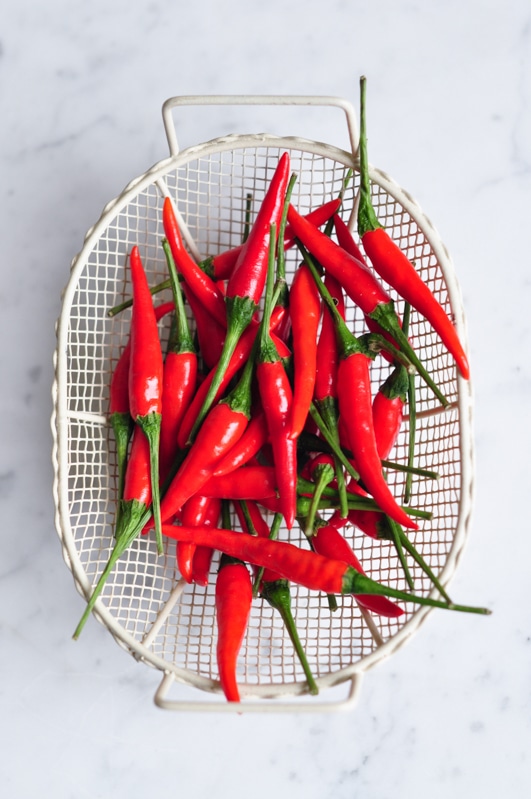 red chillies in white basket