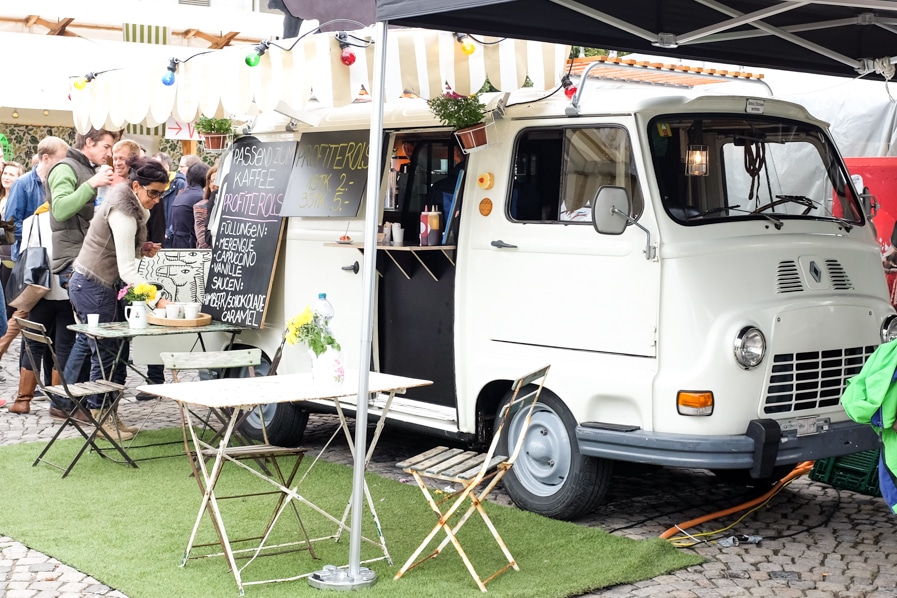 {The Kaffee & Kamele food truck serving coffee with profiteroles.}