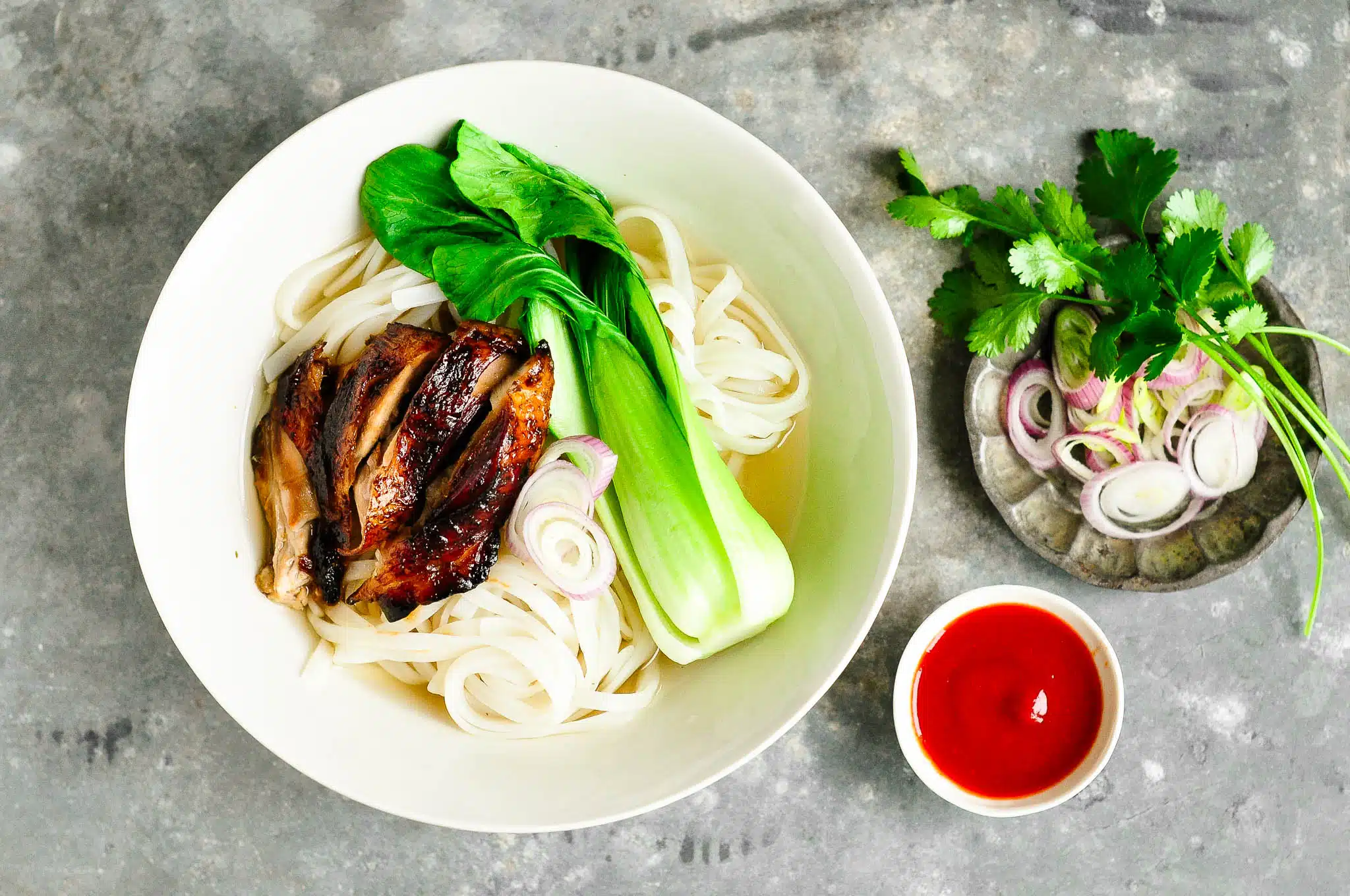 sticky chicken pho with bok choy in bowl