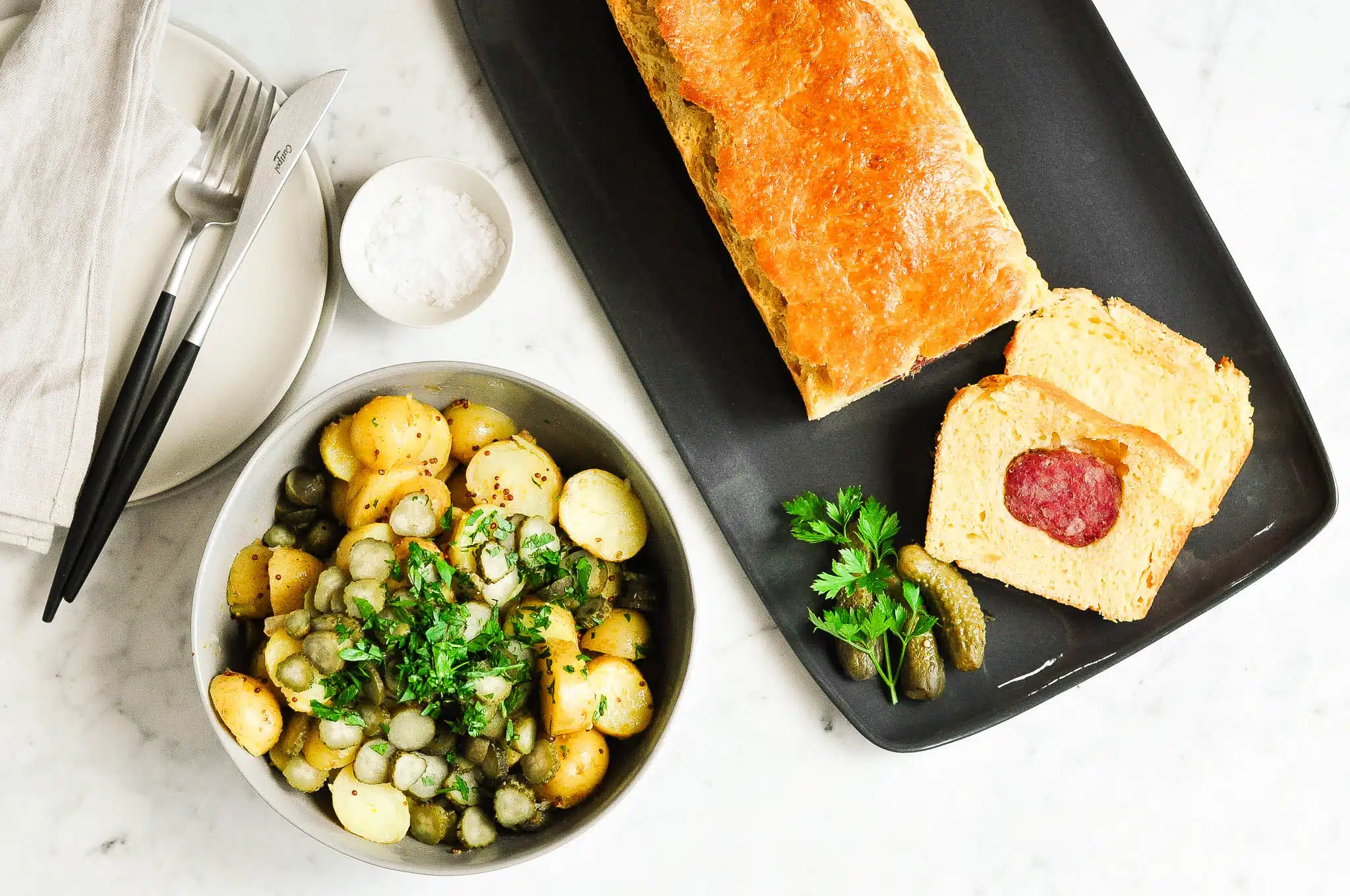 lyonnaise sausage roll with napkin on plate
