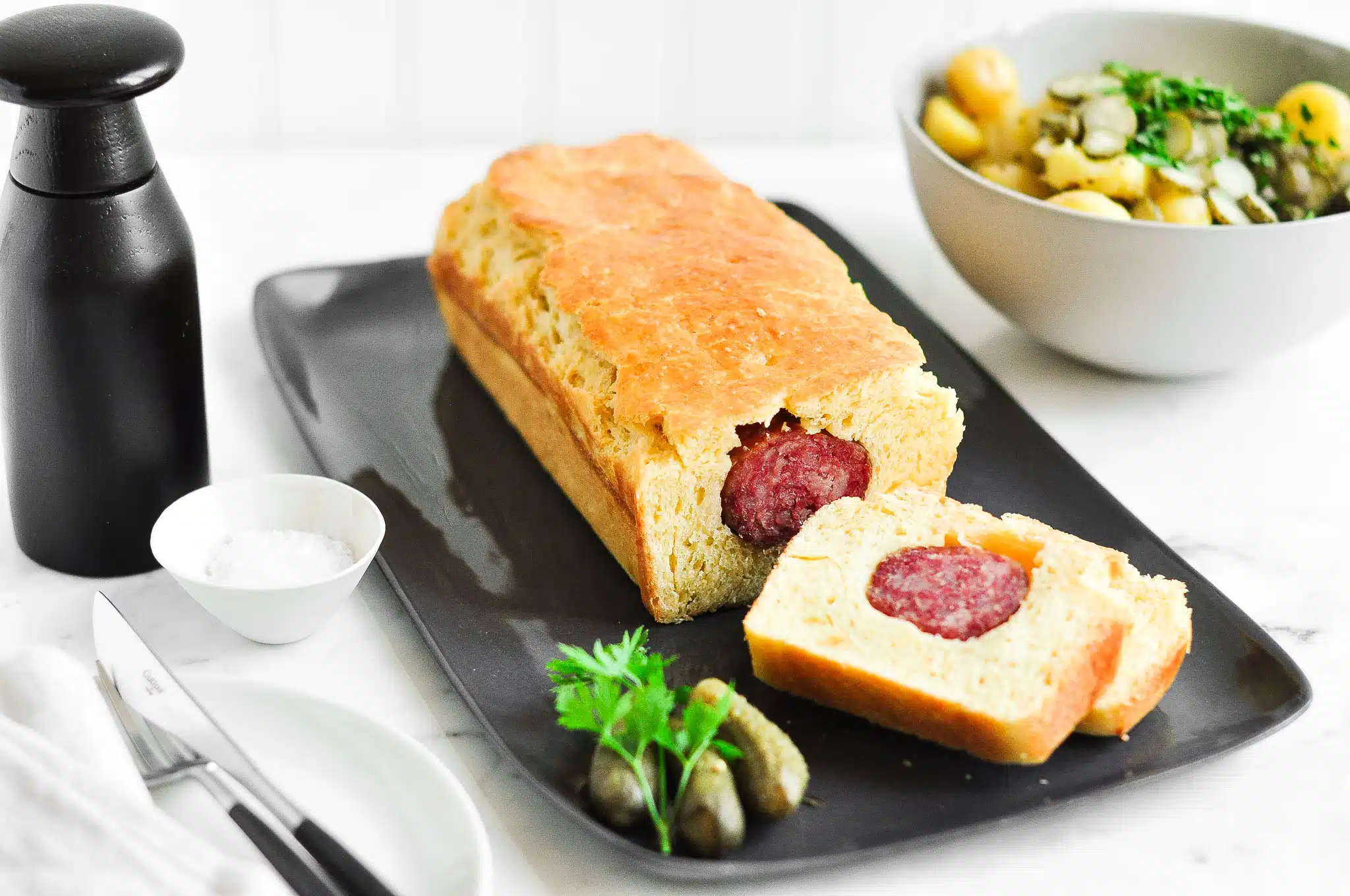 lyonnaise sausage roll with salt and pepper shaker