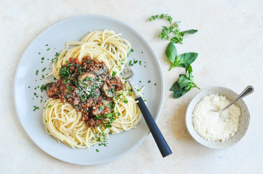 vietnamese spaghetti bolognese on plate with herbs