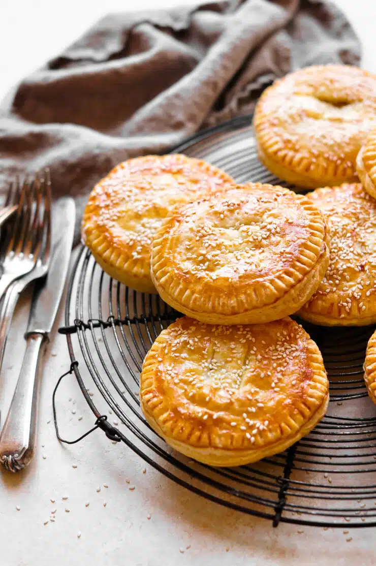 vietnamese meat pies pate chaud on wire rack with cutlery