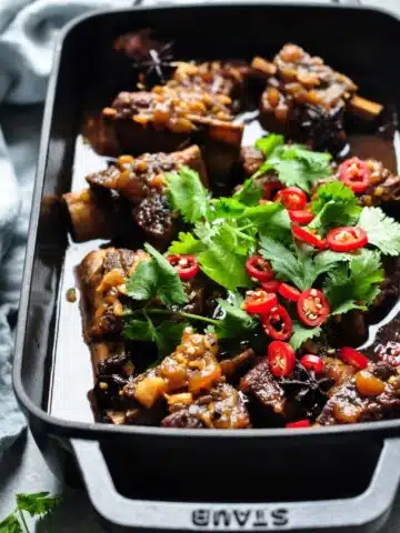 asian braised beef short ribs with chopped cilantro and chiliies