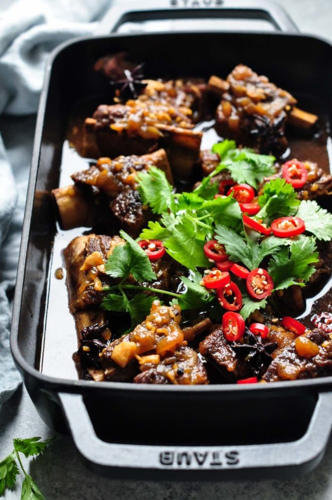 asian braised beef short ribs with chopped cilantro and chiliies
