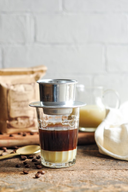 vietnamese coffee filter on glass with condensed milk