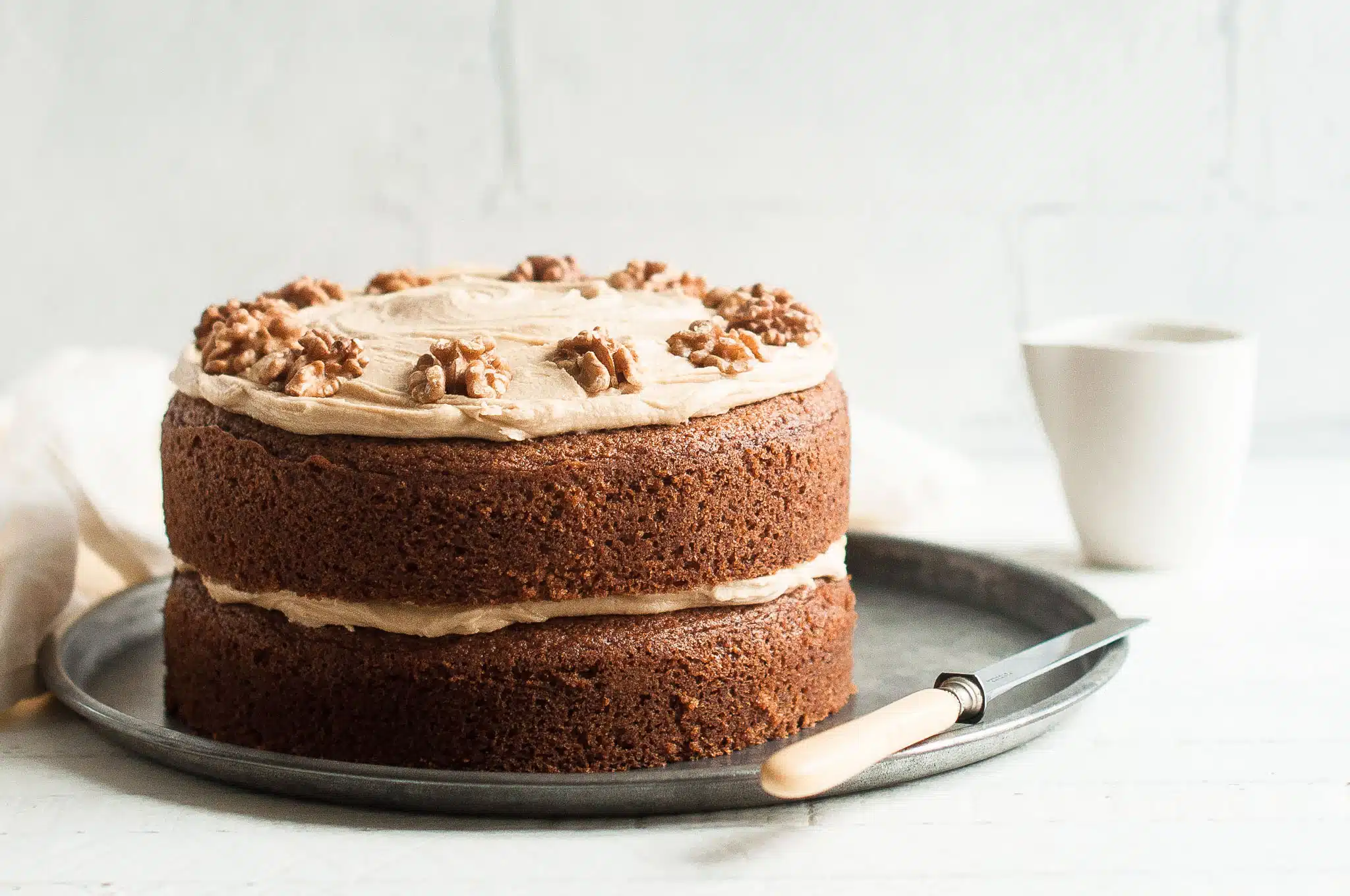 coffee and walnut cake on metal plate