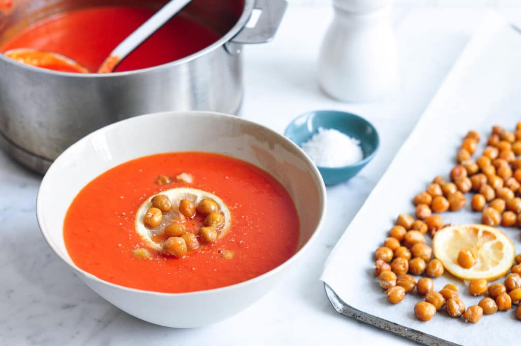 cream of tomato soup in bowl and saucepan with ladle
