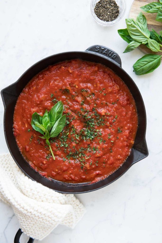easy marinara sauce or tomato pasta sauce in large saucepan with fresh herbs
