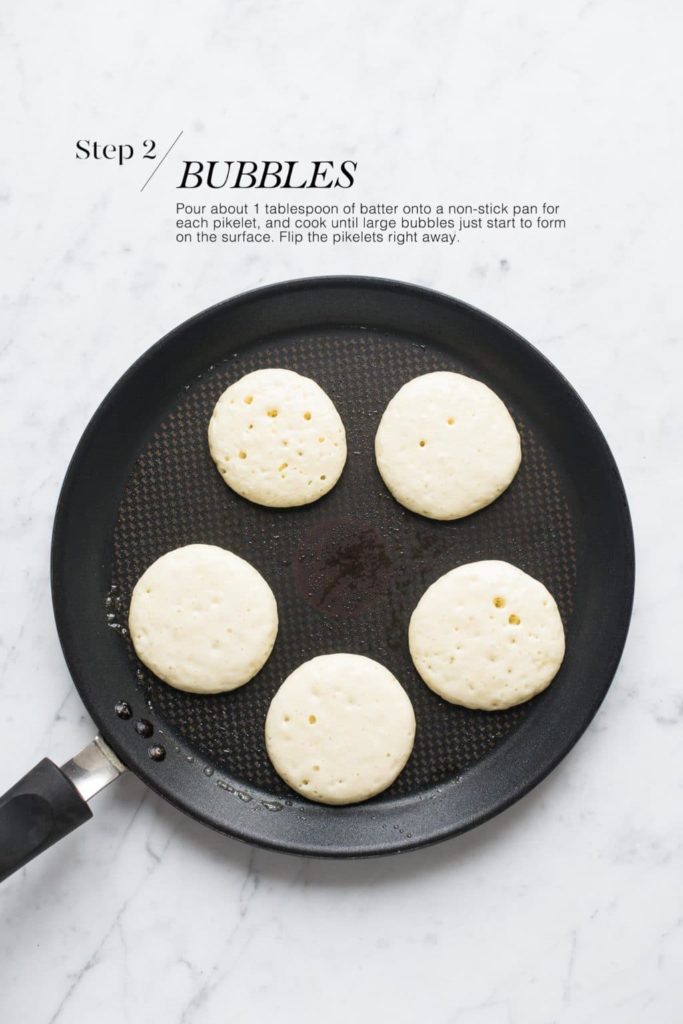 pikelets cooking on a non-stick pan