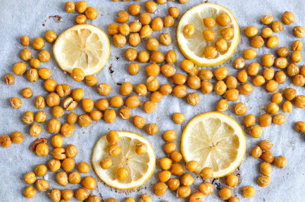 roasted chickpeas and lemon slices on baking tray