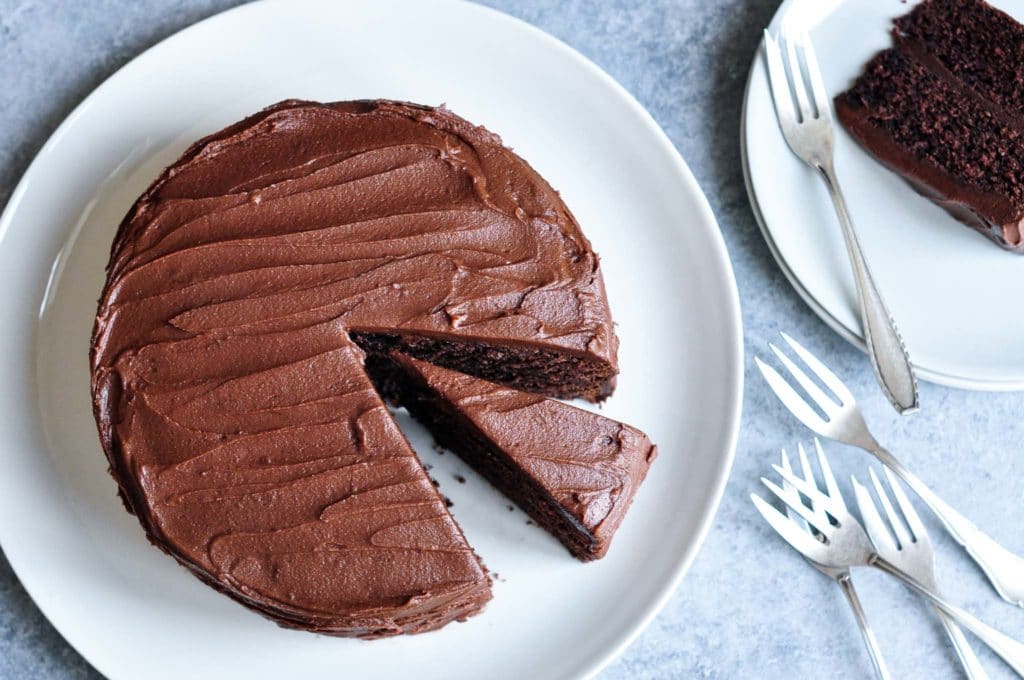 sour cream chocolate cake on plate with slice removed