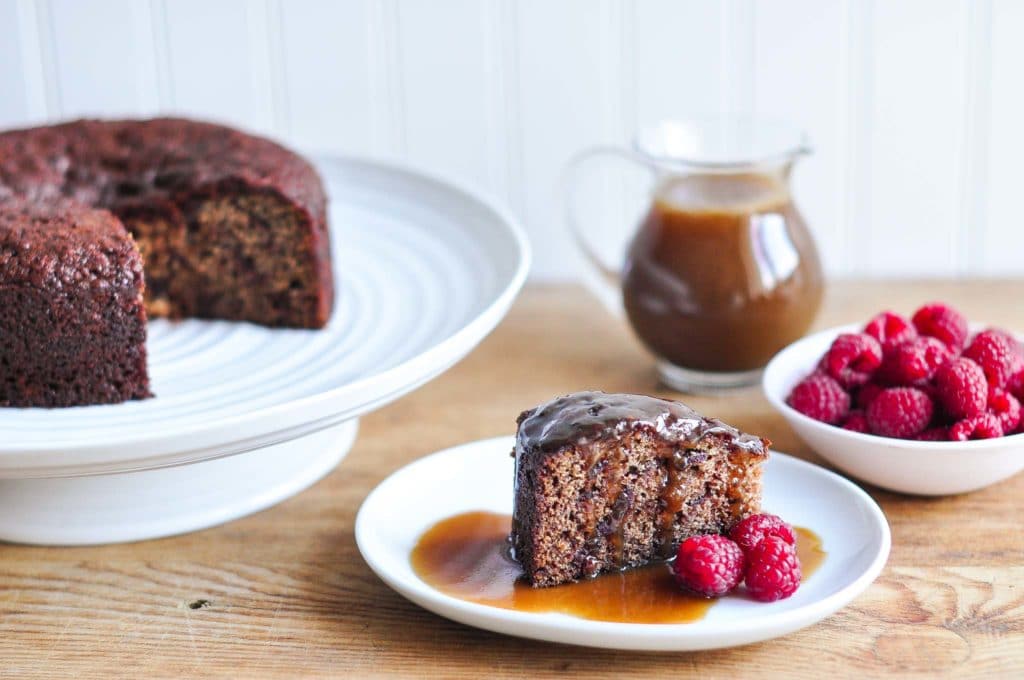 slice of sticky toffee pudding or sticky date pudding drizzled with butterscotch sauce