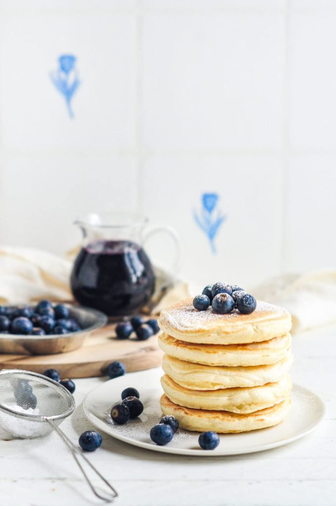 easy fluffy pancakes with powdered sugar and fresh blueberries