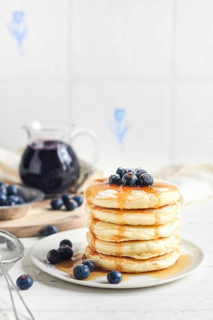 easy fluffy pancakes with blueberry sauce with vintage strainer