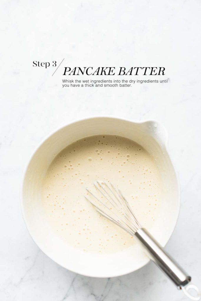 pancake batter in white mixing bowl with metal whisk