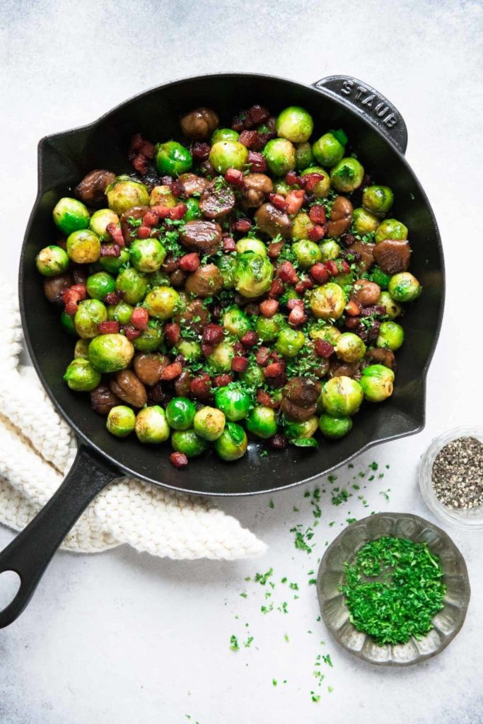 brussels sprouts with chestnuts and pancetta in black skillet