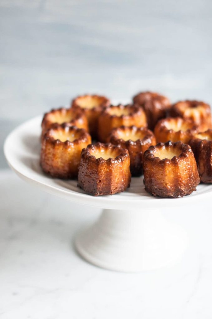 canneles on white cake stand