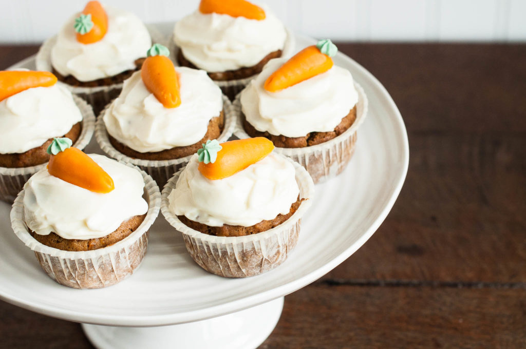 carrot cupcakes with cream cheese frosting on cake stand