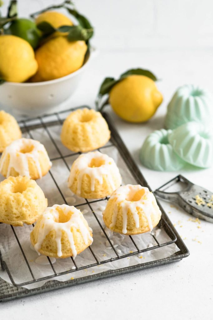 lemon bundt cakes on wire rack with silicon bakeware in background