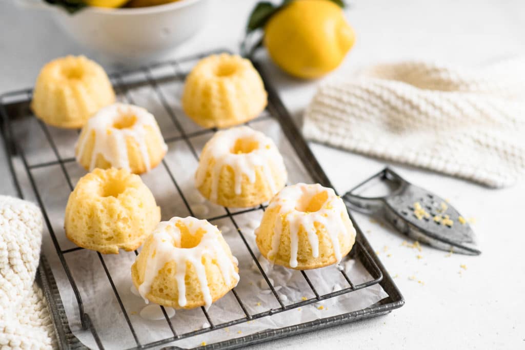 mini lemon bundt cakes on cake rack drizzled with lemon glaze