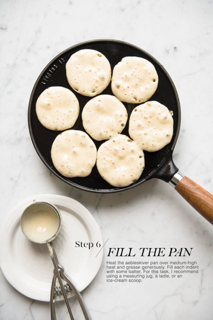 cast-iron aebleskiver pan filled with batter