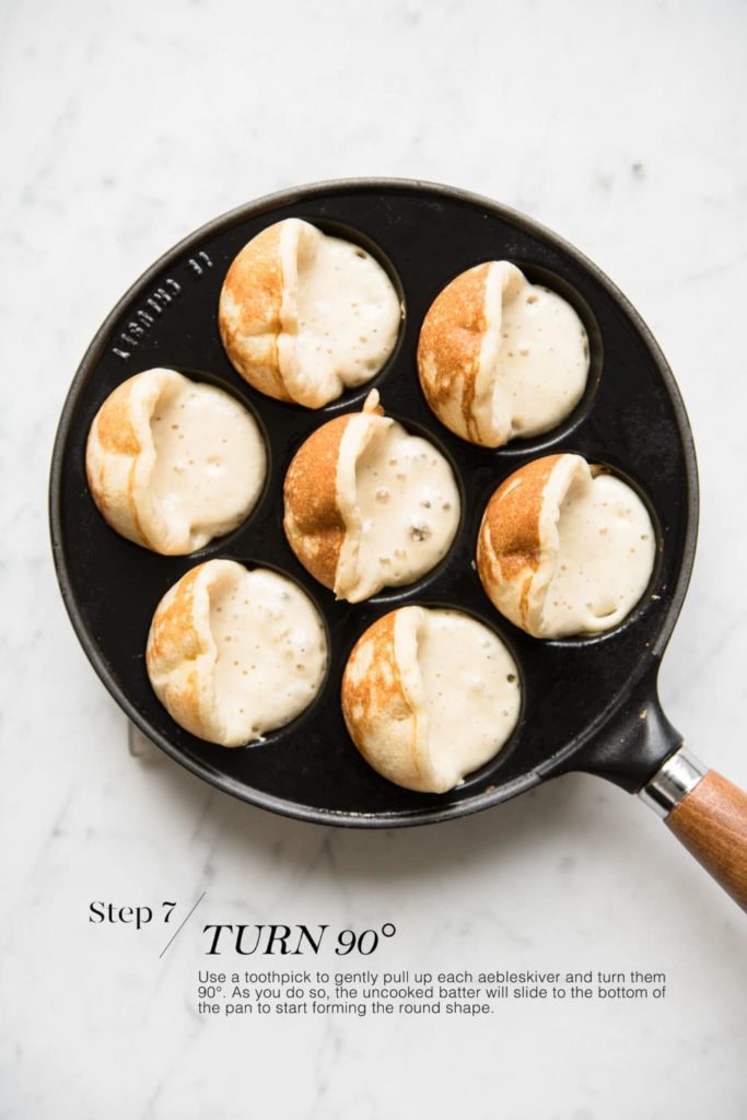 cast-iron aebleskiver pan with aebleskivers turned 90 degrees