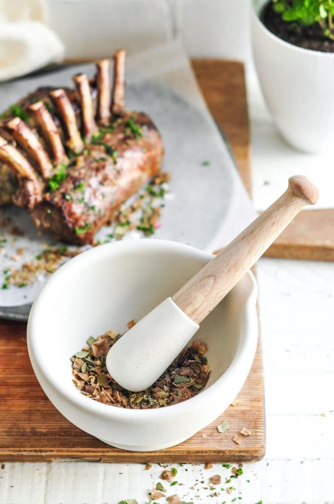 mortar and pestle with roast lamb racks in background