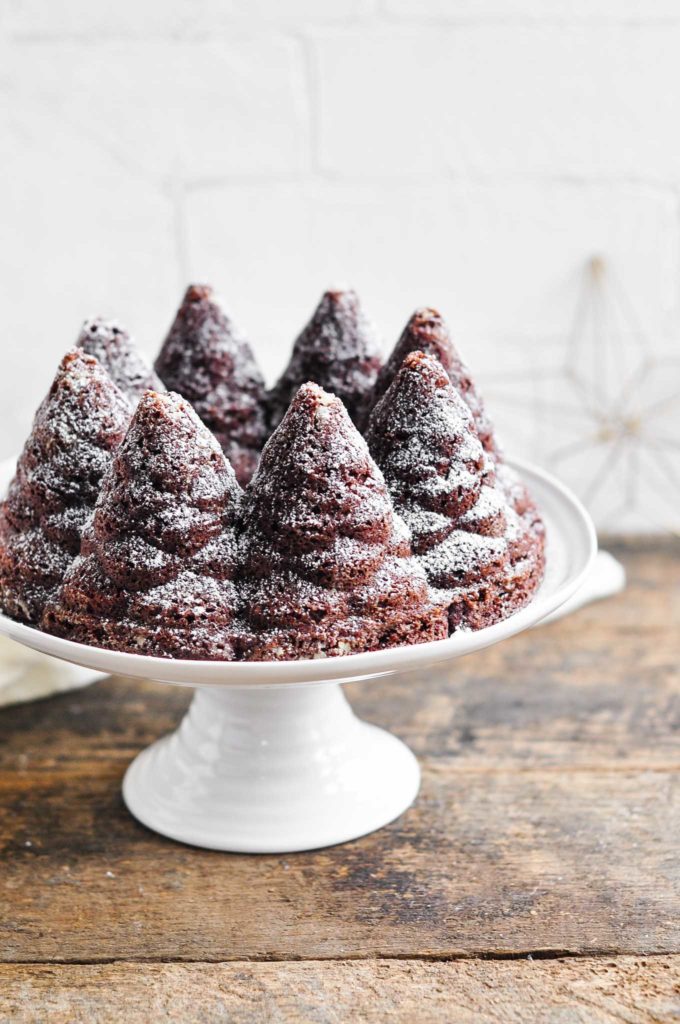 chocolate gingerbread bundt cake on white cake stand