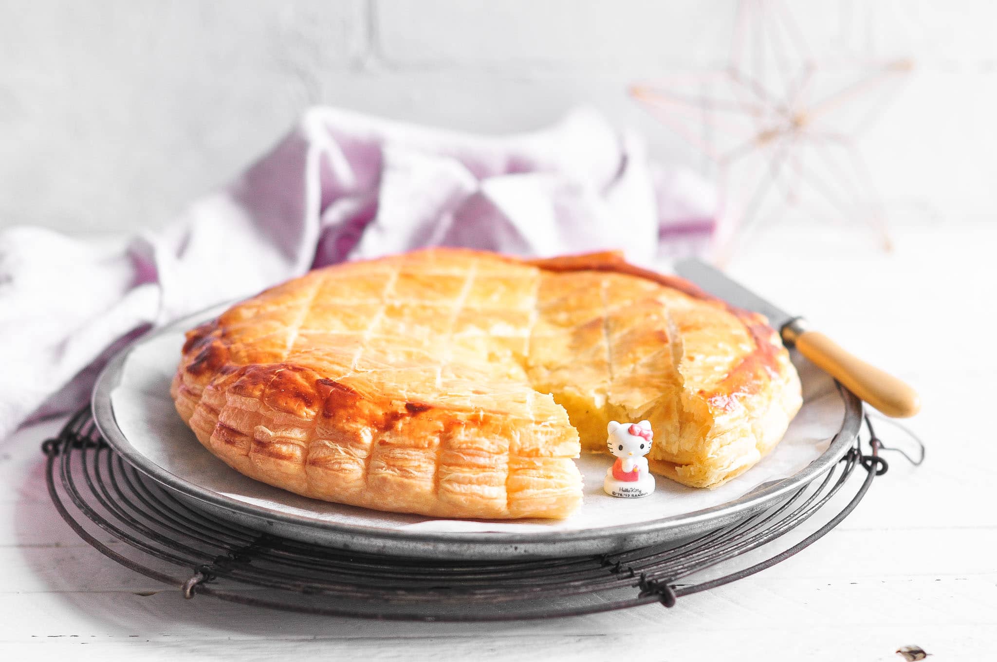 galette des rois on wire rack with hello kitty feve