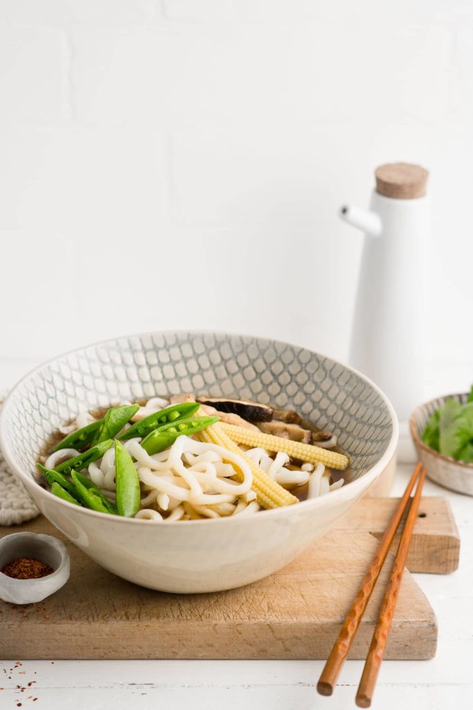 udon noodle soup in large bowl with vegetables