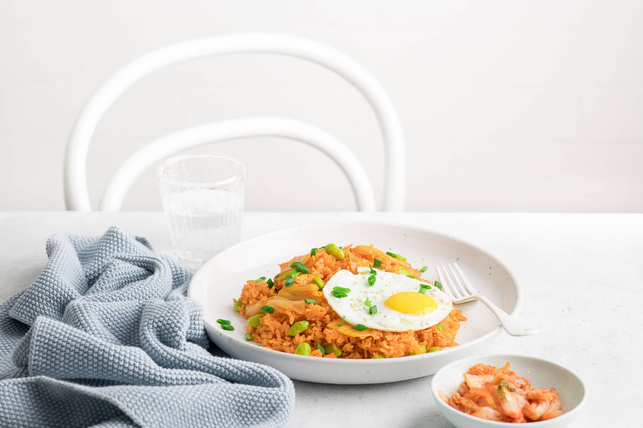 kimchi fried rice in white bowl with fried egg
