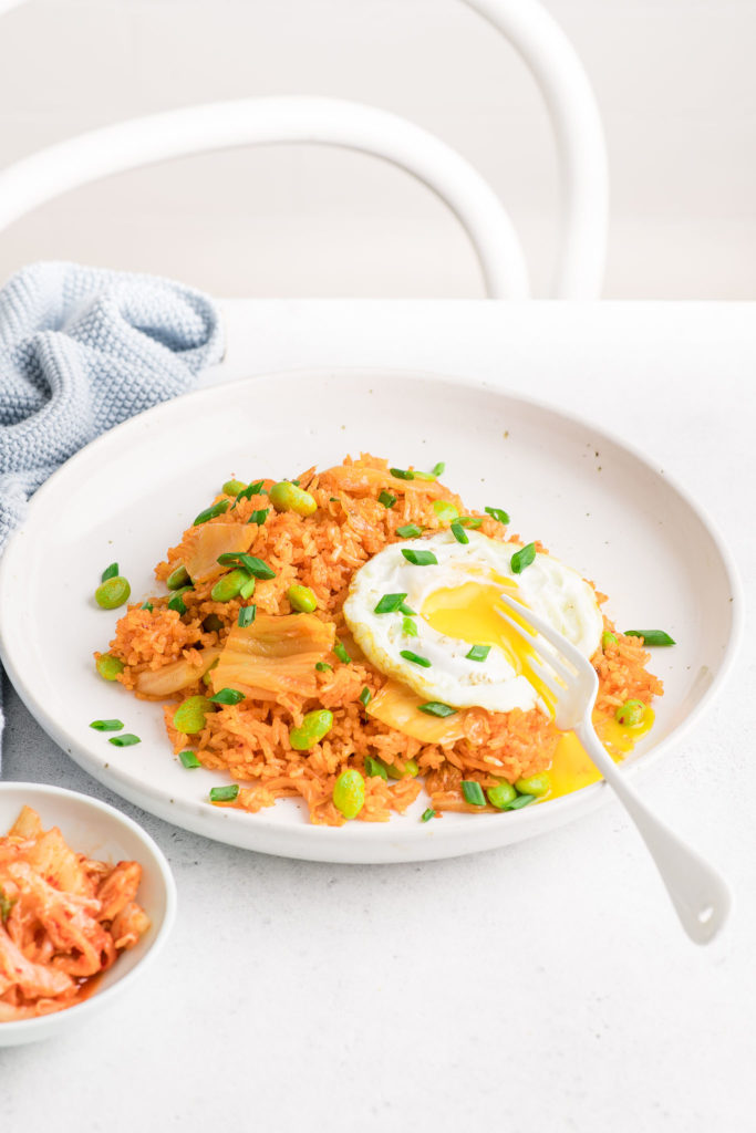 kimchi fried rice on white plate with fried egg