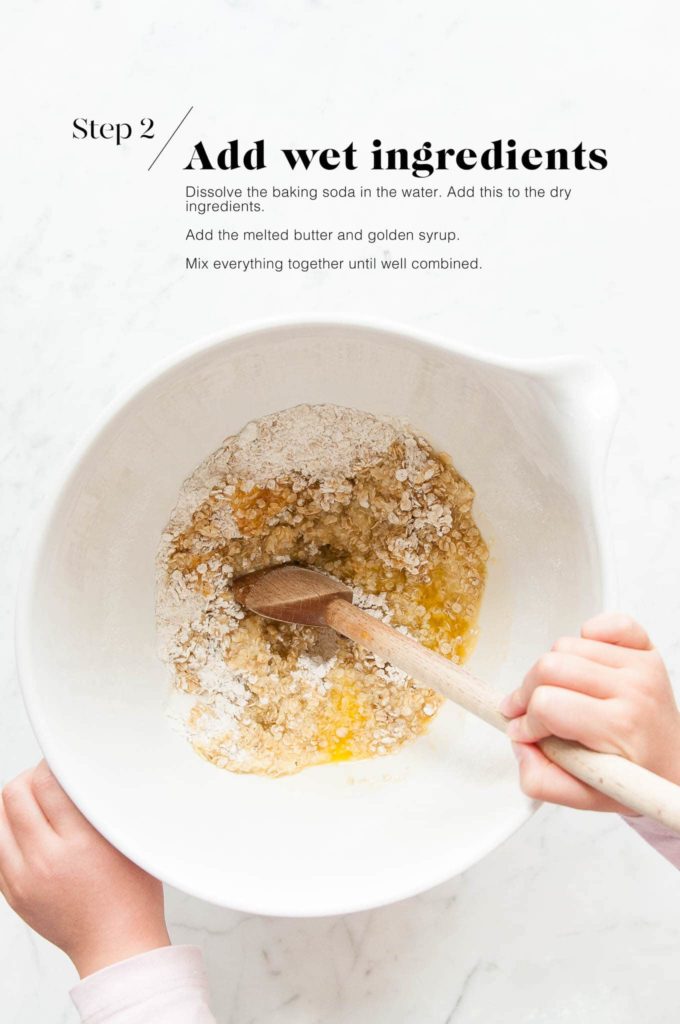 anzac biscuit mixture in white mixing bowl