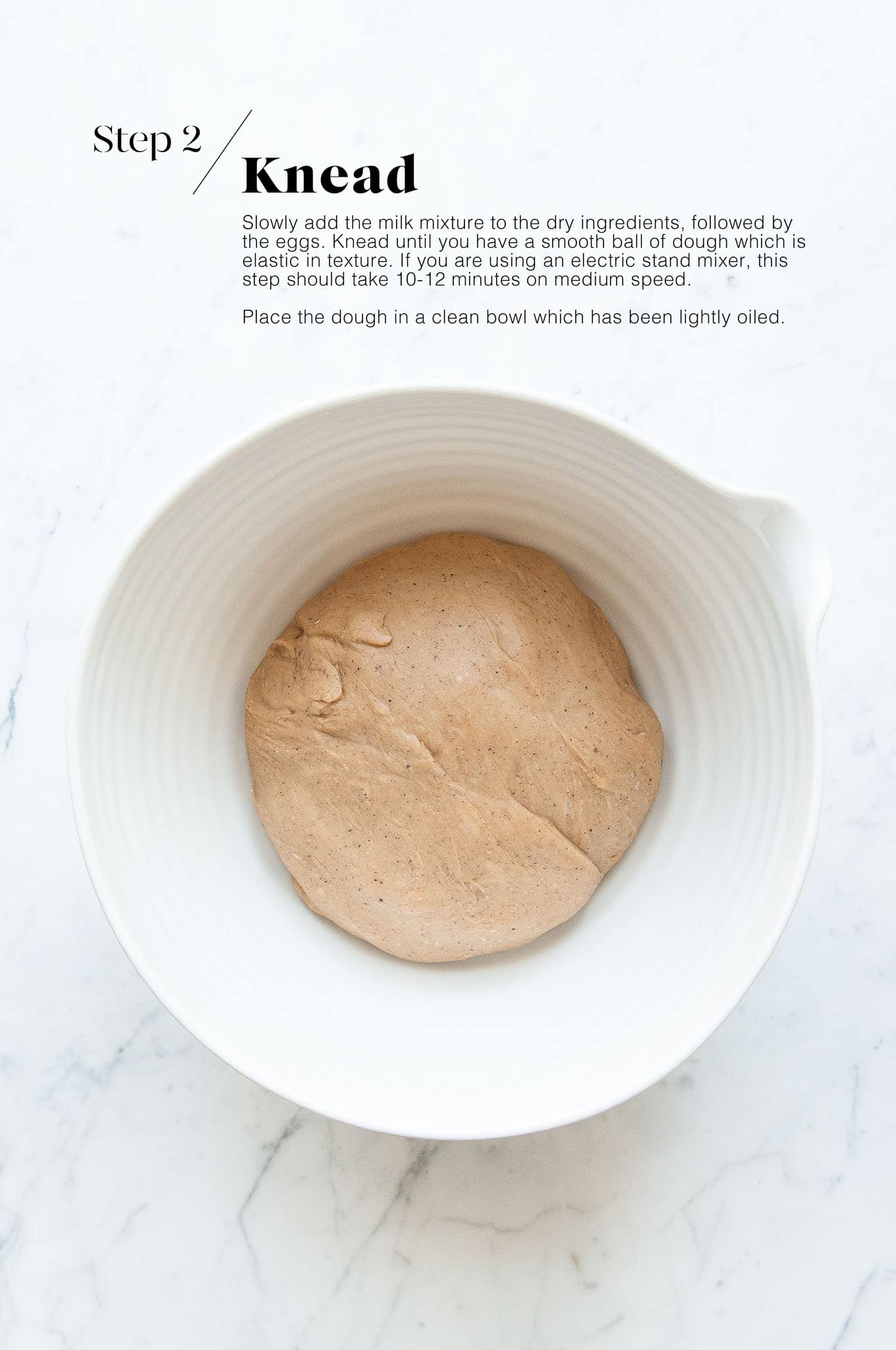 dough for hot cross buns in white mixing bowl