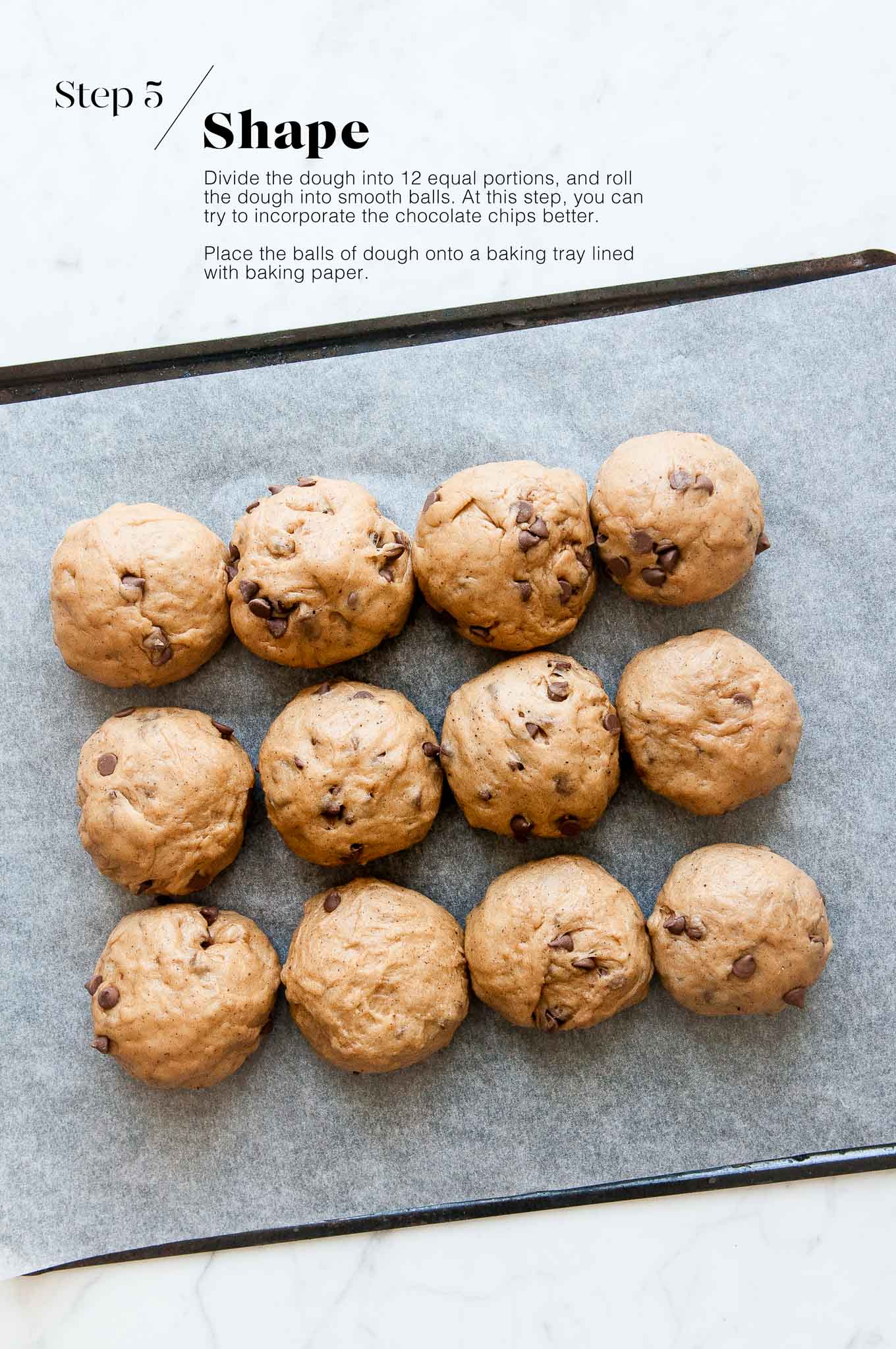 shaped dough for chocolate chip hot cross buns on baking tray