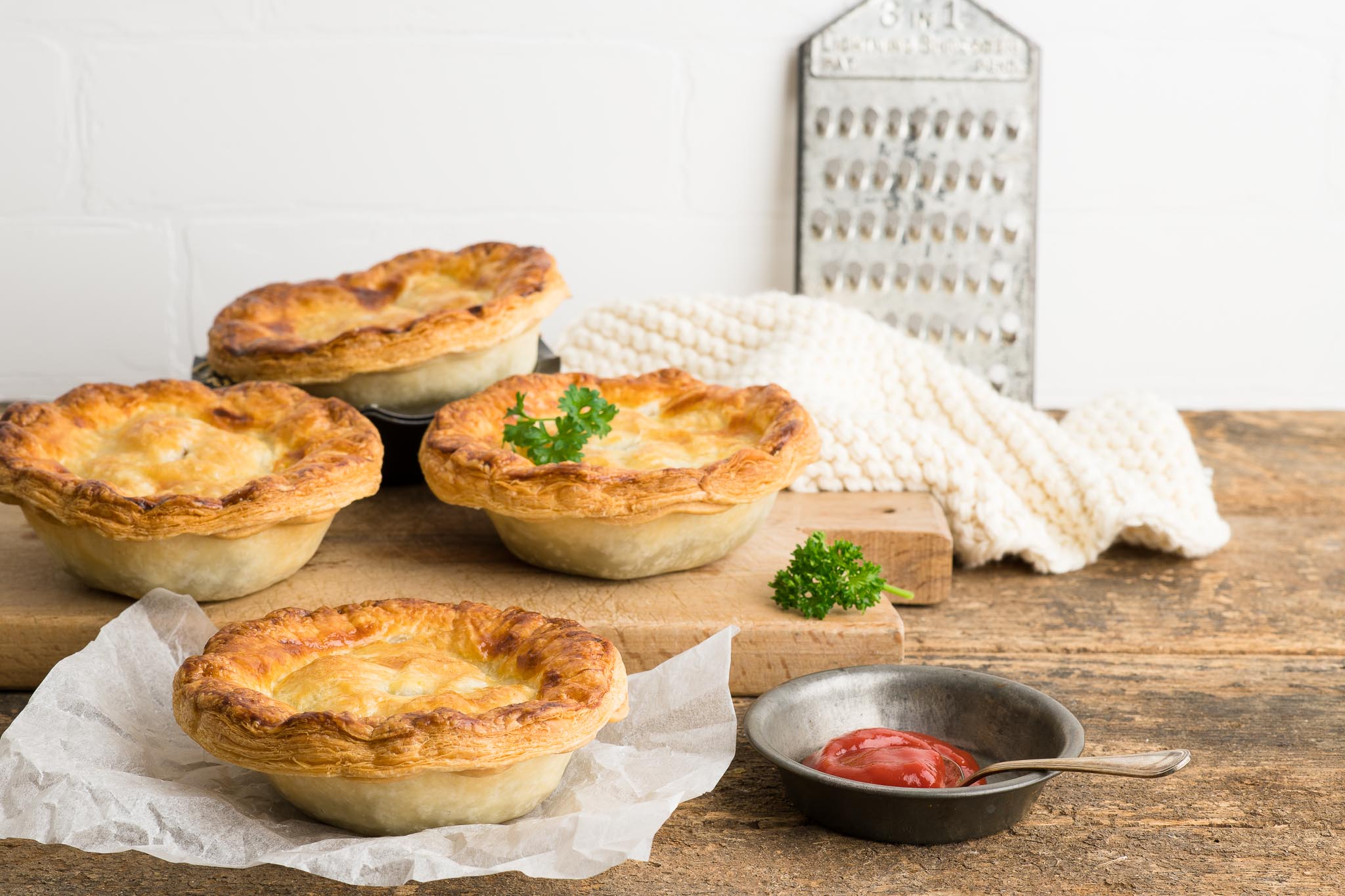 meat pies with beef and guinness filling on wooden board