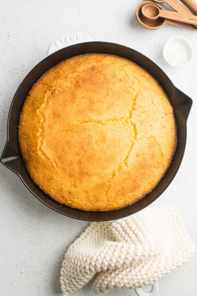 cornbread in skillet with knitted cloth