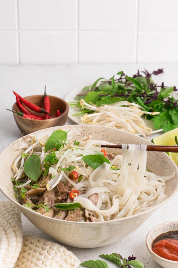 vietnamese pho noodle soup with chopsticks