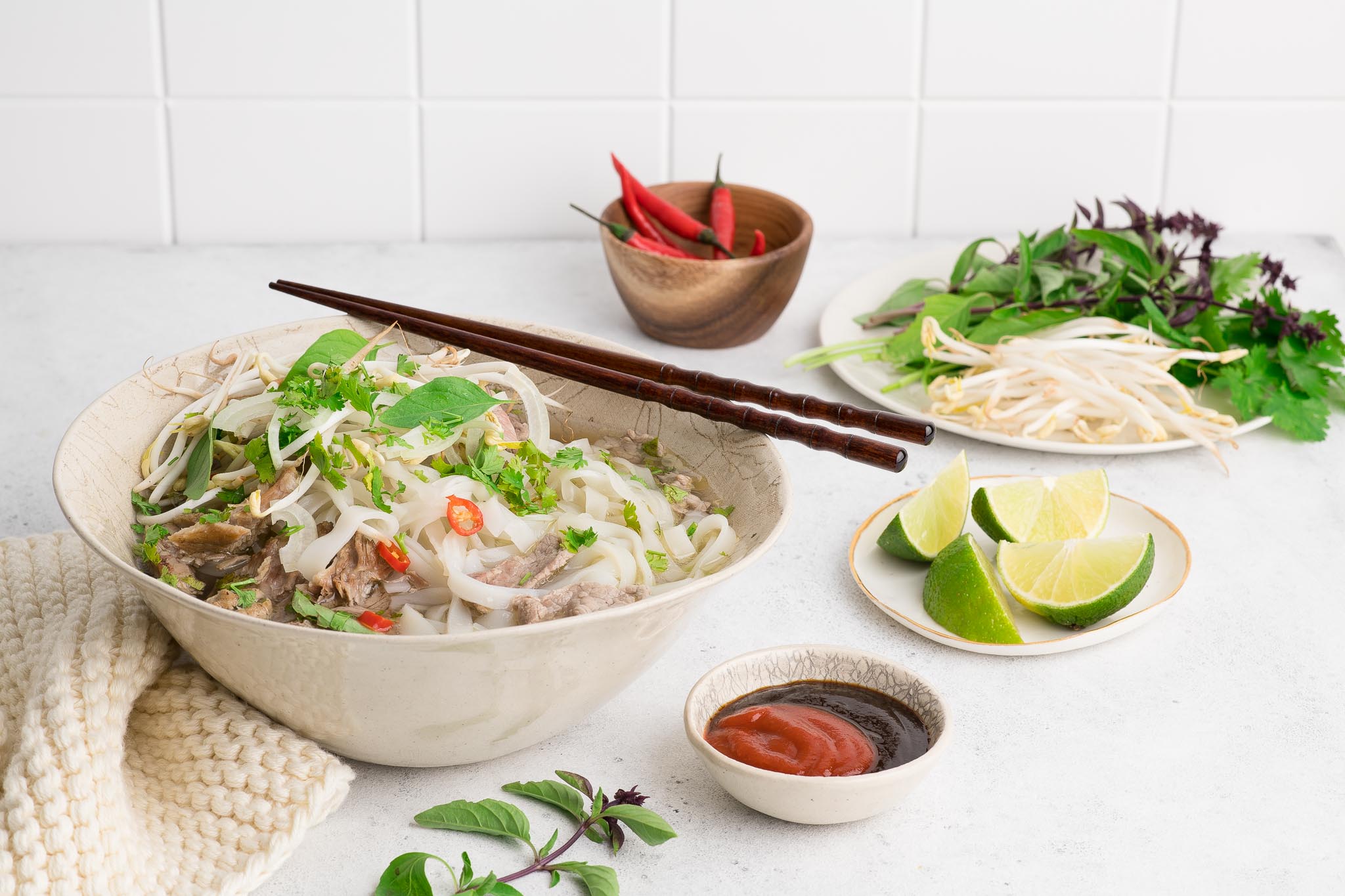 vietnamese pho in large bowl with fresh herbs