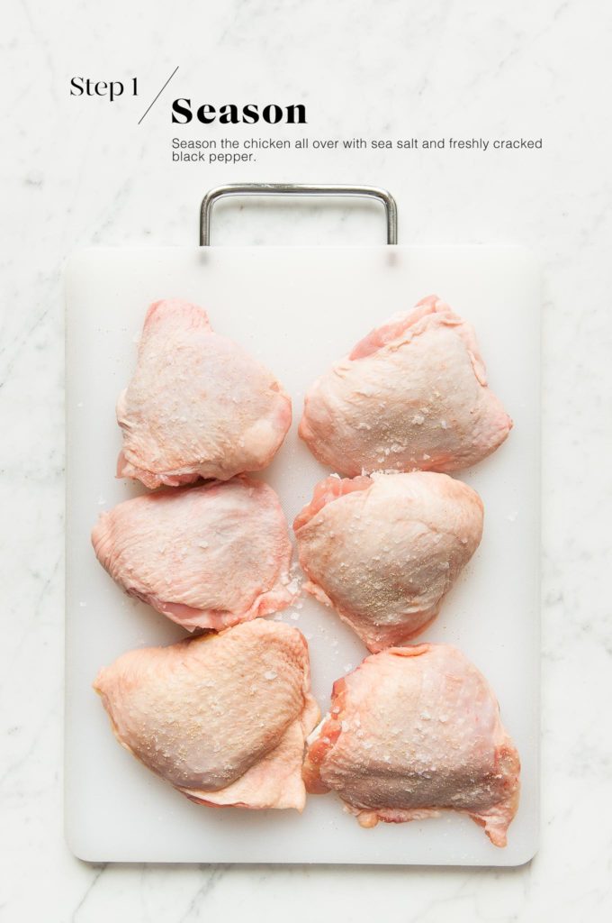 raw chicken thighs on white chopping board